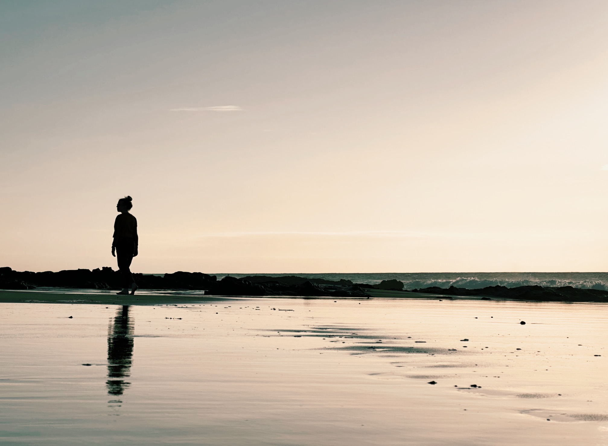 Silhouette of women hiking on beach at sunset on Fuerteventura, Canary Islands, Spain