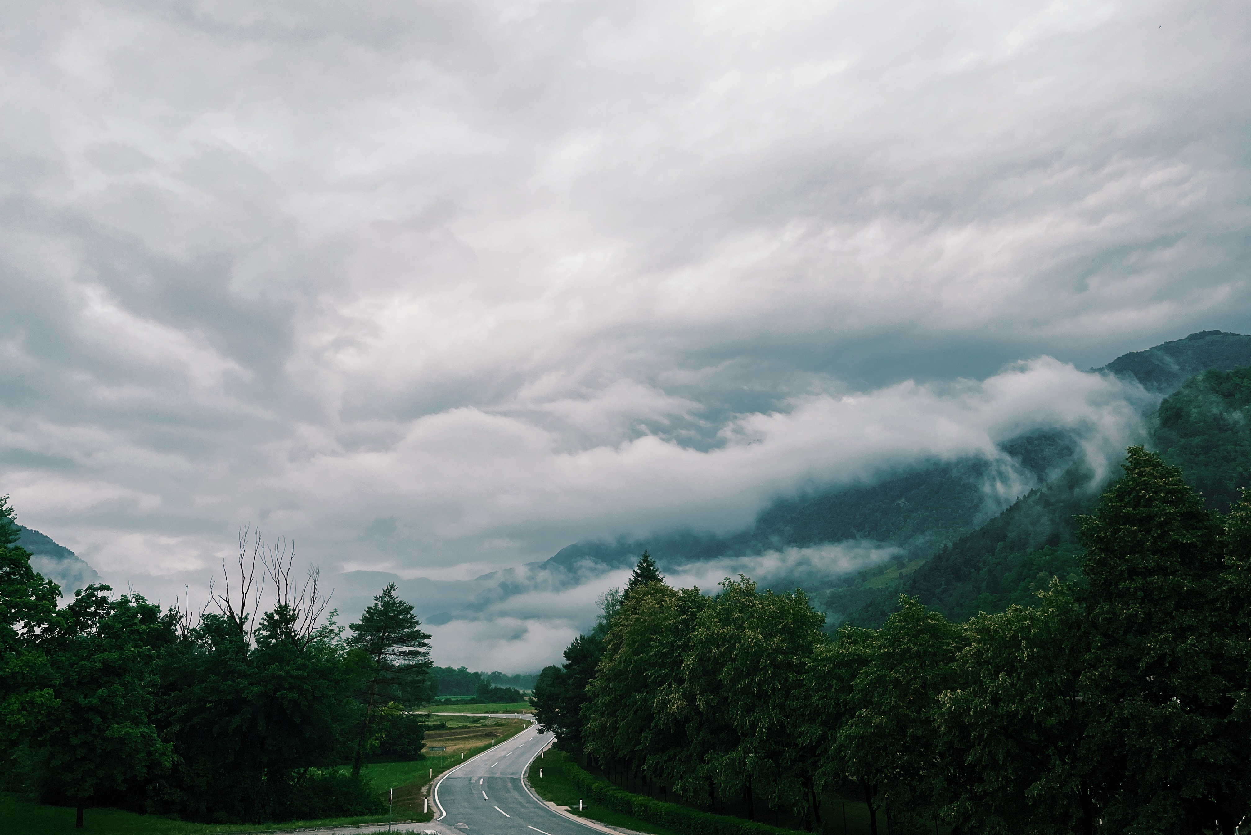 Cloudy sky over a road in the Soca Valley, Slovenia on the Alpe Adria Trail, the best thru-hiking trail for beginners