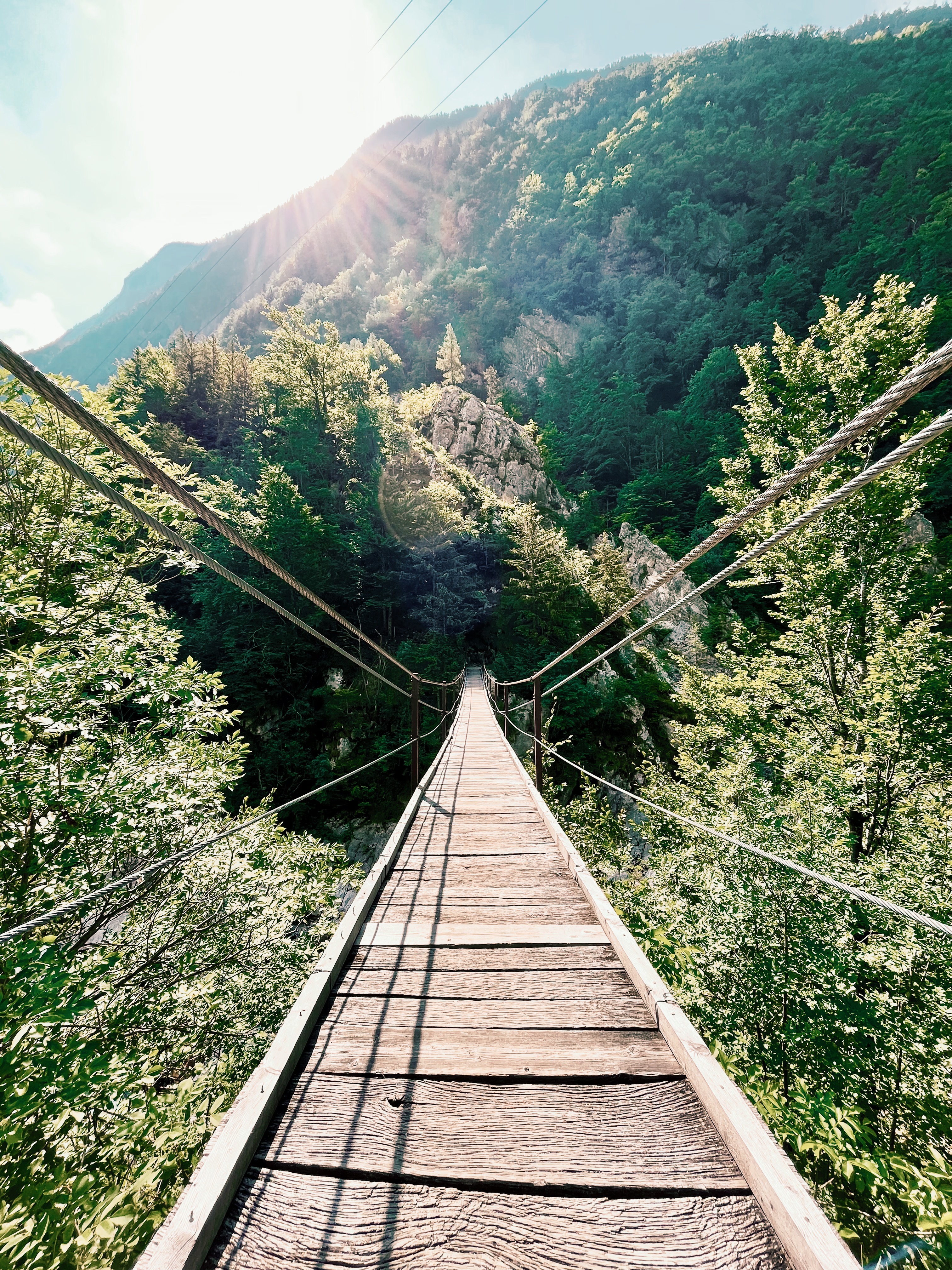 Bridge over Soca river on the Alpe Adria Trail, a long-distance hiking trail in Europe